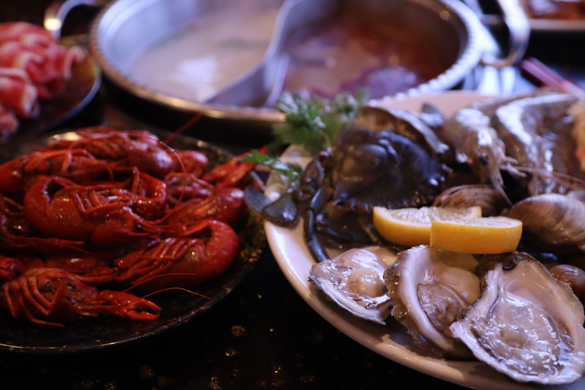 Bright red crawfish, oysters, shrimp, and shellfish prepared for the LaMeiZi table